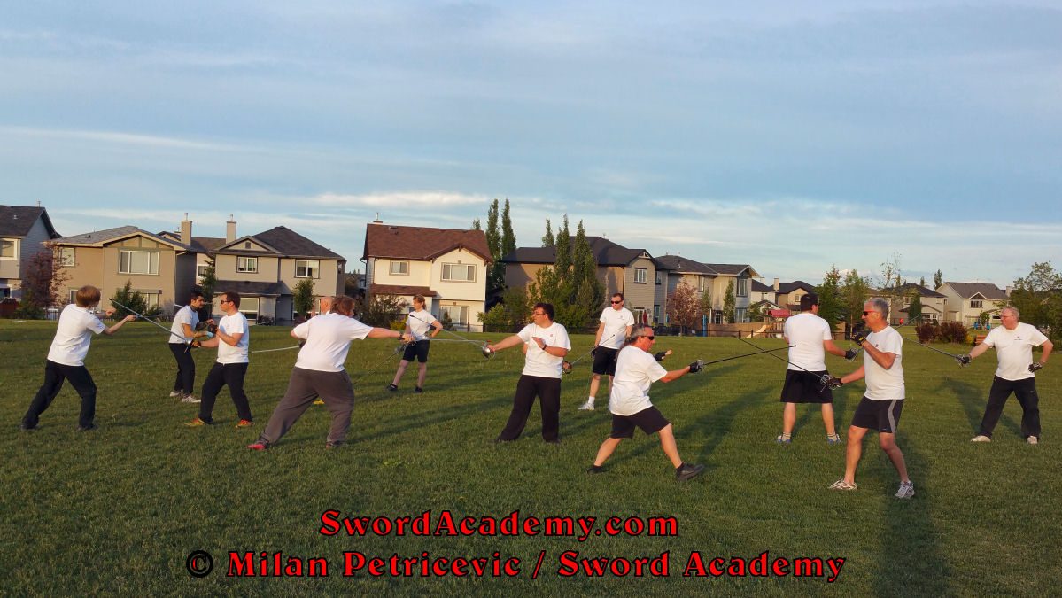 Sword Academy students in an outdoor class execute in pairs rapier exercise / drill inspired by historical sources from the Italian renaissance tradition, part of Sword Academy HEMA / WMA / Martial Arts curriculum.