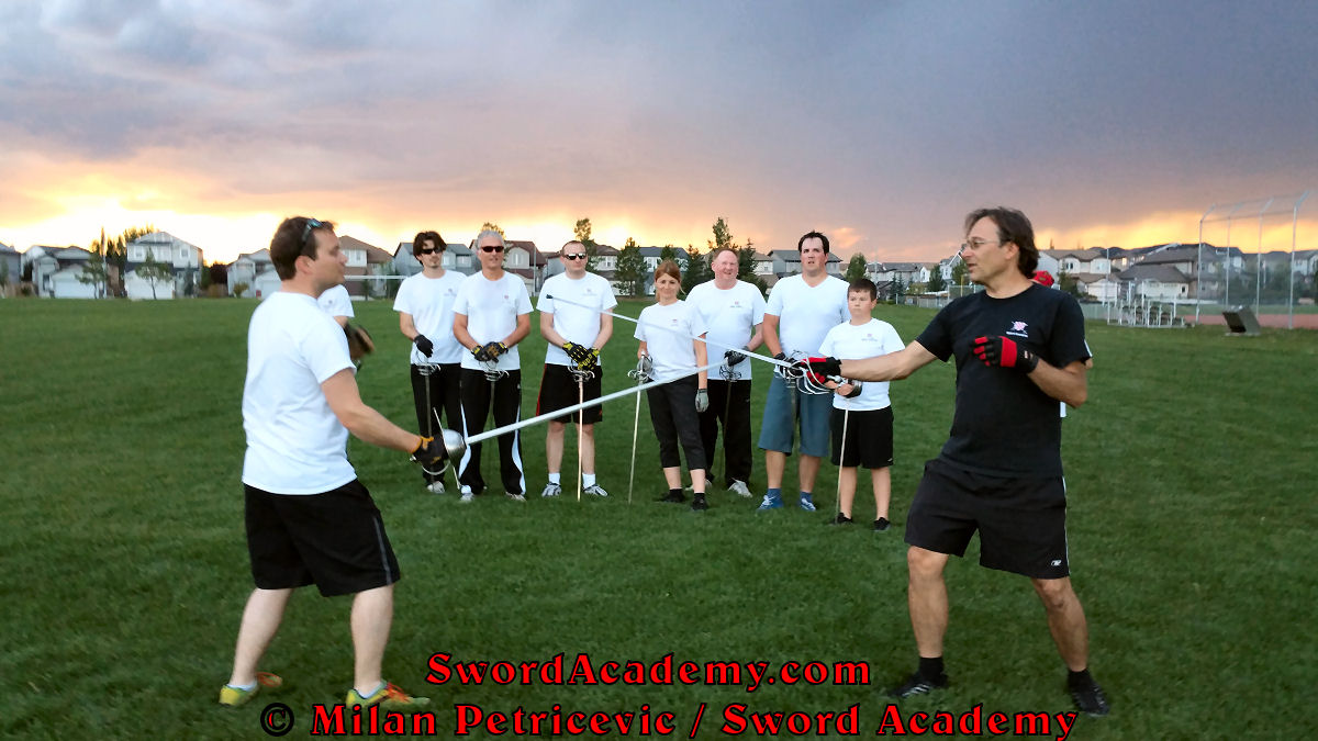 Milan demonstrates during an outdoor class with the inspiring sunset in front of Sword Academy students the rapier exercise / drill using Terza guard inspired by historical sources from the German medieval and renaissance tradition, part of Sword Academy HEMA / WMA / Martial Arts curriculum.