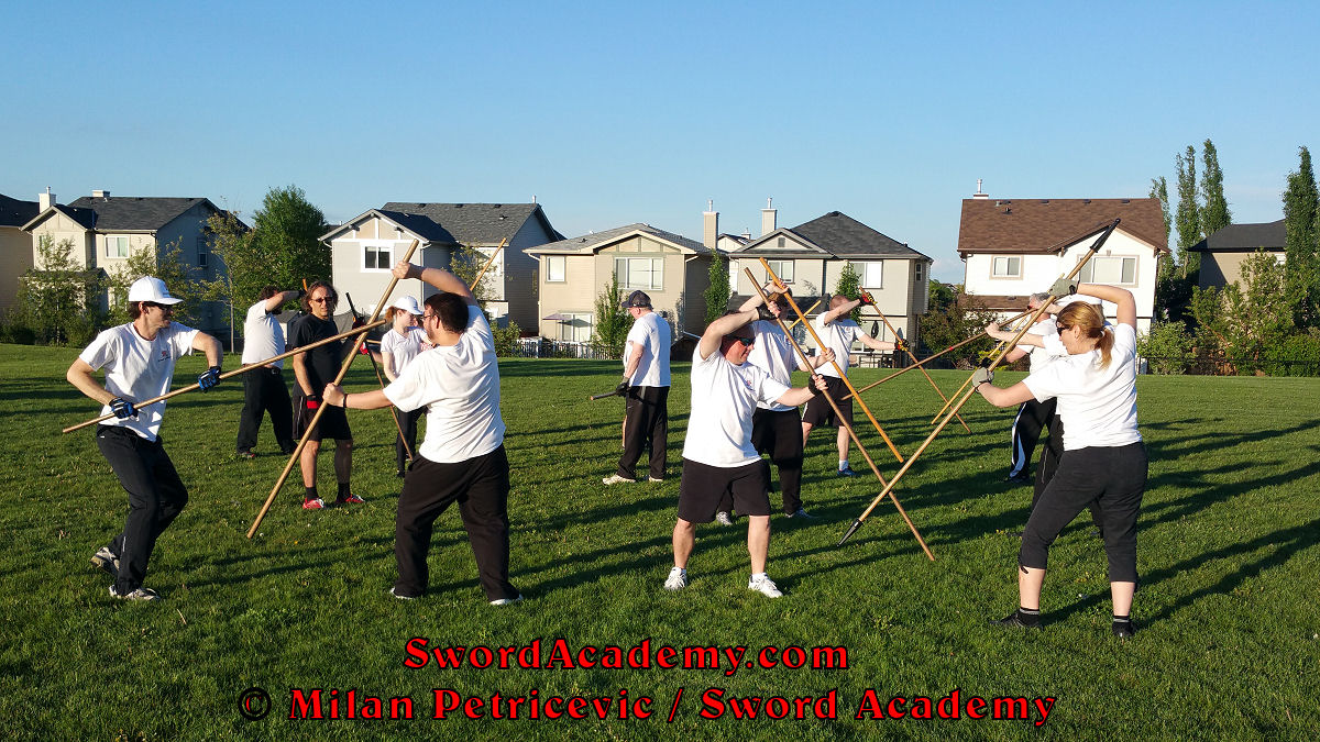 Sword Academy students in an outdoor class under Milan's supervision executes staff exercise / drill inspired by historical sources from the German renaissance tradition, part of Sword Academy HEMA / WMA / Martial Arts curriculum.