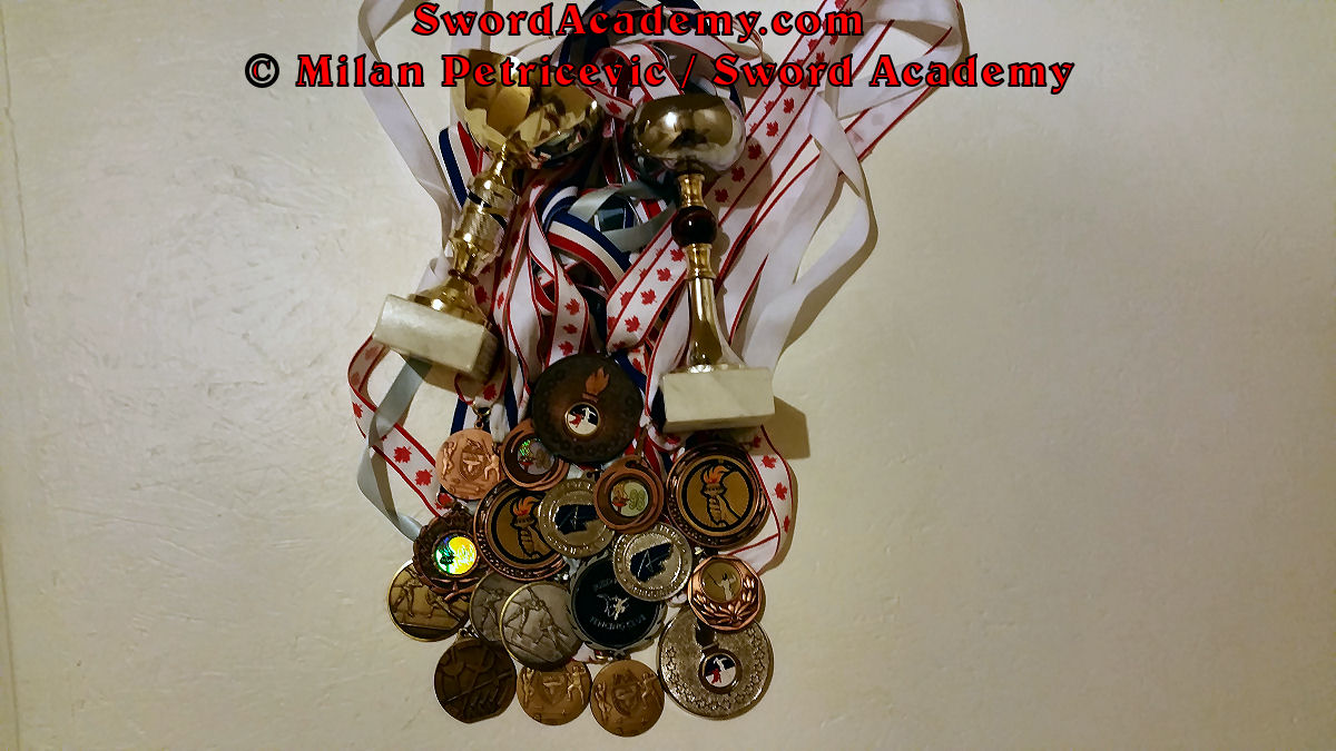 Some of Milan's fencing achievements are illustrated by the fencing medals and cups from Europe and Canada. Displayed trophies include multiple medals from international fencing tournaments, Western Canadian Championships, Alberta Provincial Championships, etc in all three fencing disciplines: epee, foil and sabre.